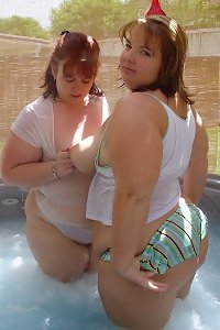 undoubted bbw women in sultry embrace, rubbing each other intimately
